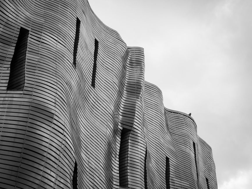 black and white wave art installation building facade