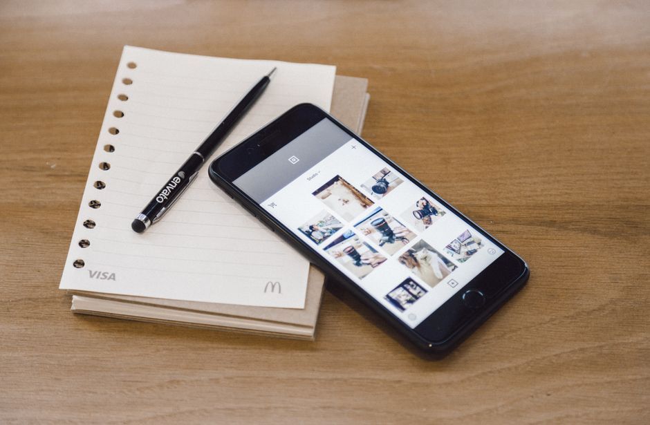 smartphone travel app screen office desk workspace