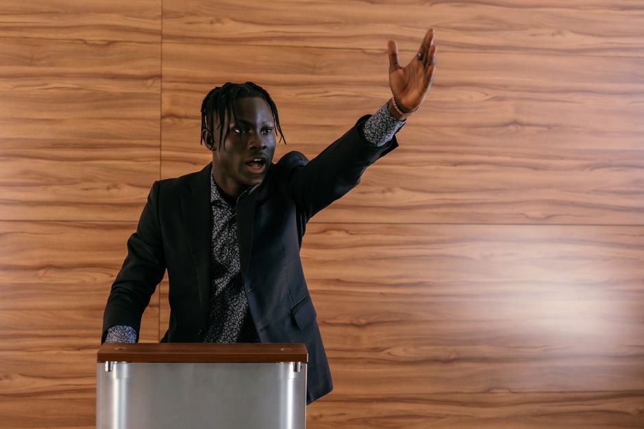 UK politician speaking at conference podium