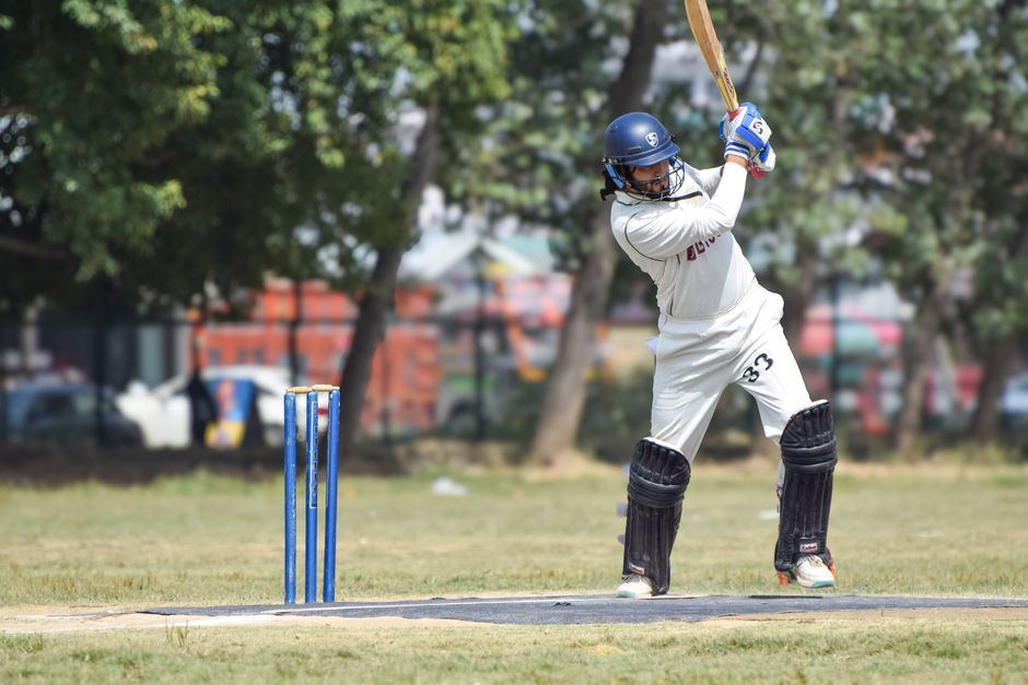 cricket player action pitch stadium