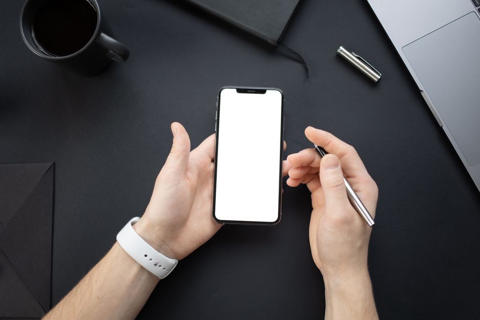 consumer electronic device holding hands modern office desk