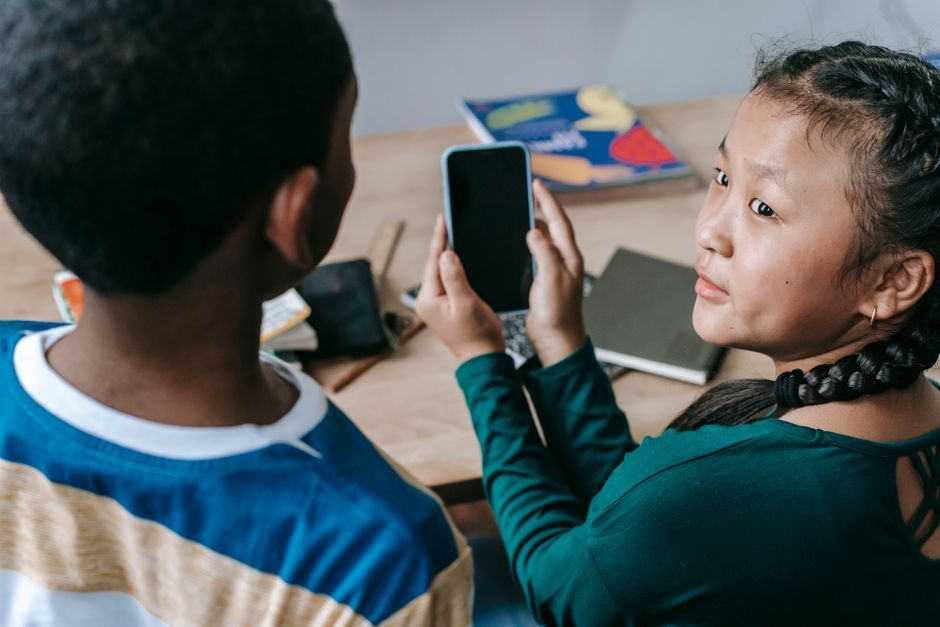 students using smartphones classroom