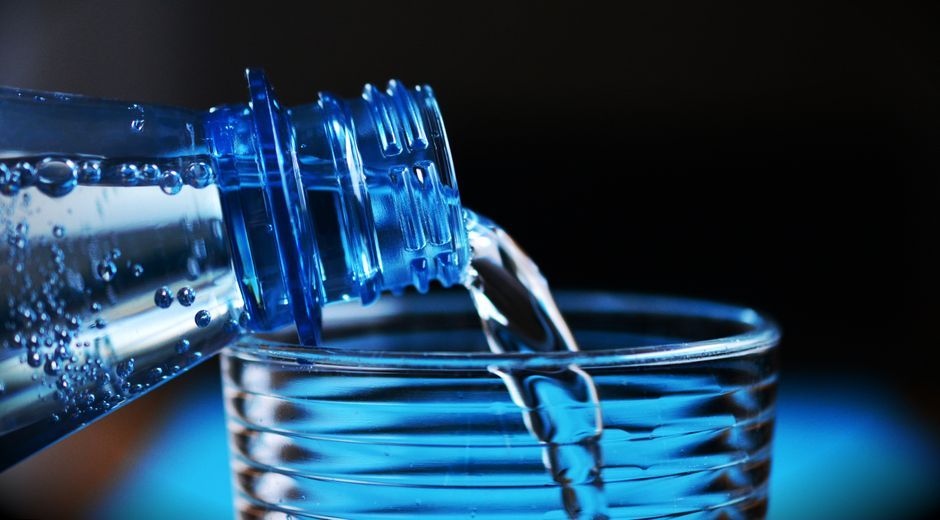 pouring sparkling water into glass