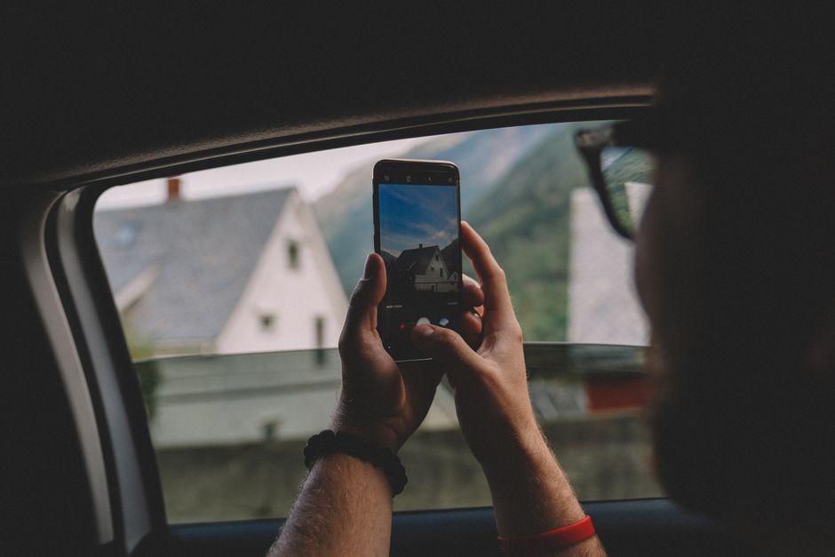 person taking photo with smartphone