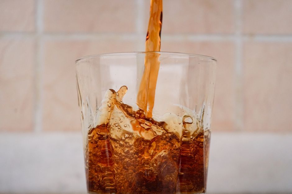 pouring diet soda glass