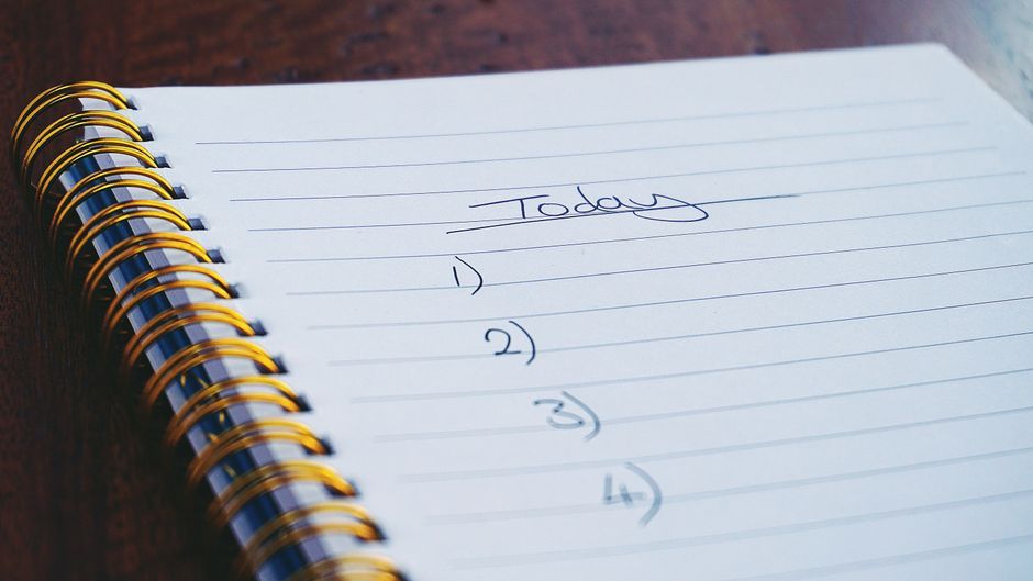 notebook paper with handwritten contact lists