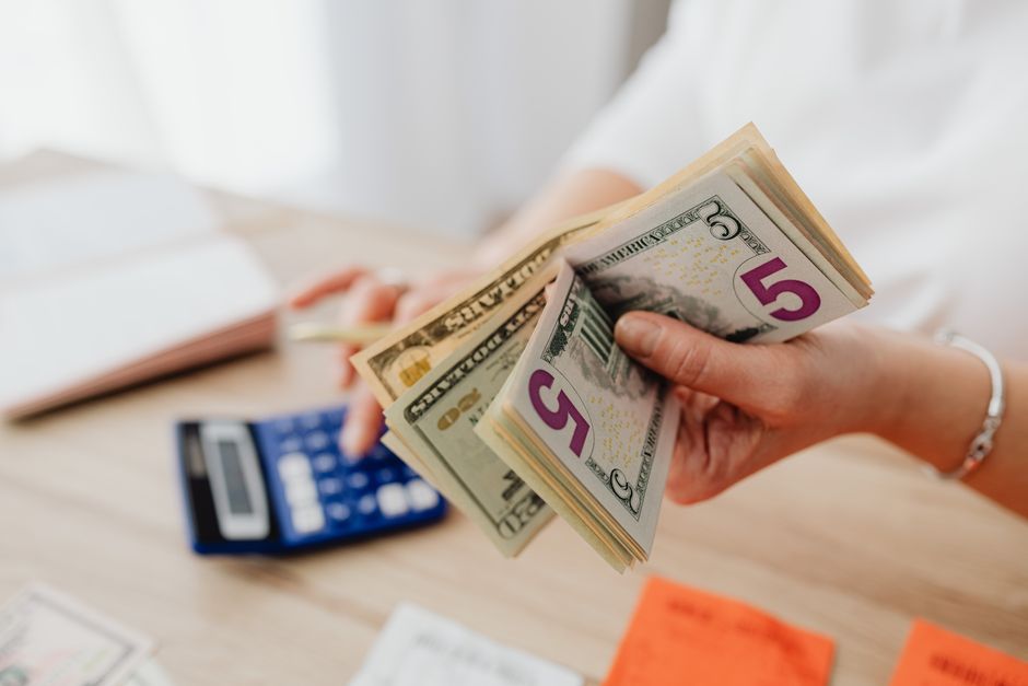 UK business woman calculating savings