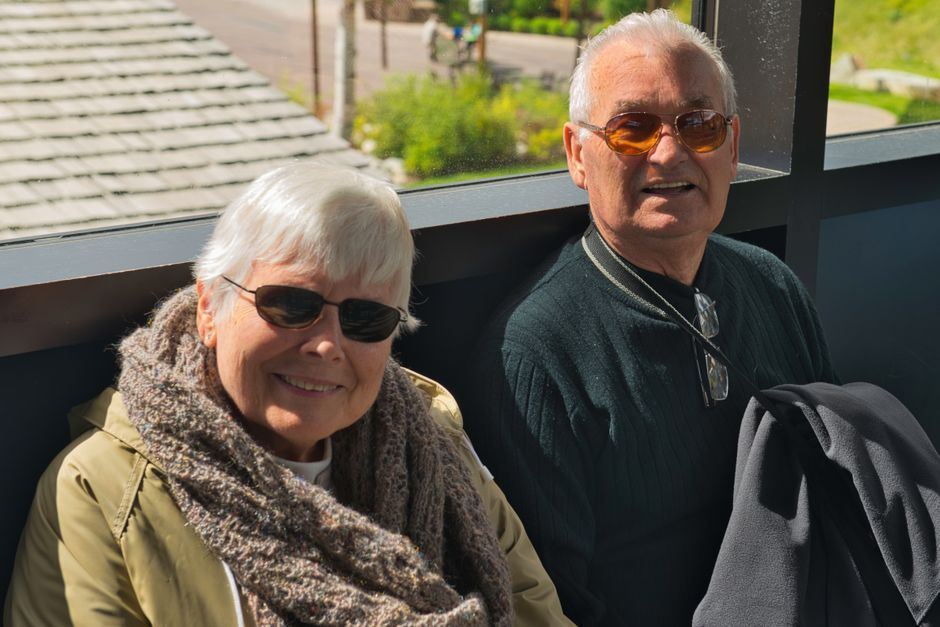 older traveler couple smiling outdoors