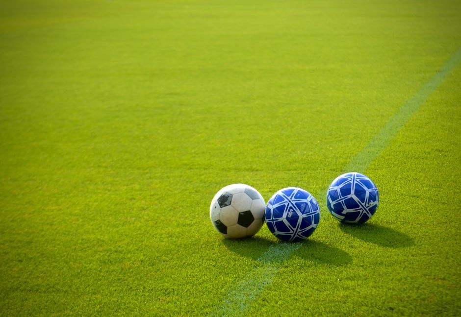 soccer ball on green grass pitch