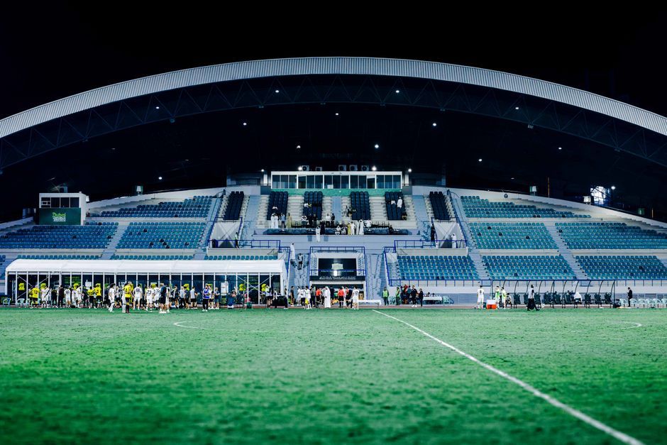 soccer stadium floodlights night match crowd no team crest