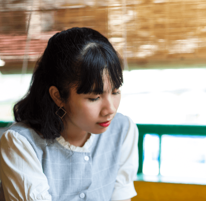 thoughtful Thai woman portrait interior setting