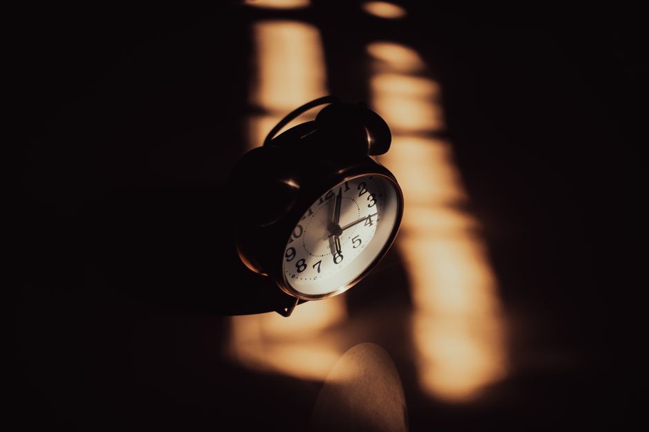 alarm clock morning sunlight bedroom interior