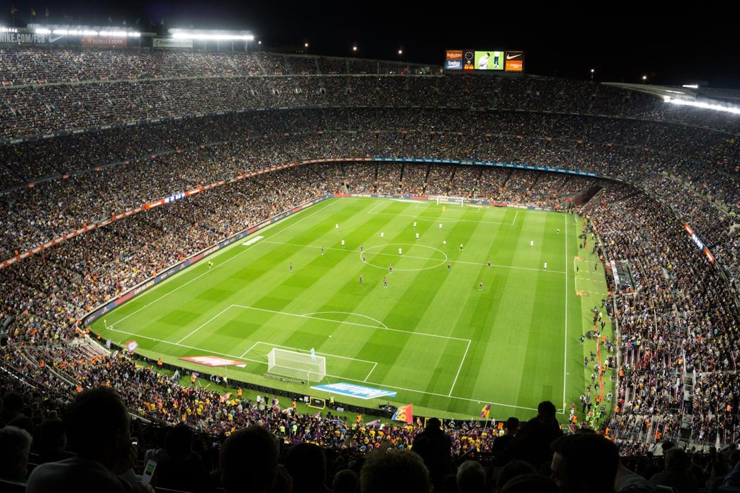 soccer stadium floodlights night match crowd no team crest