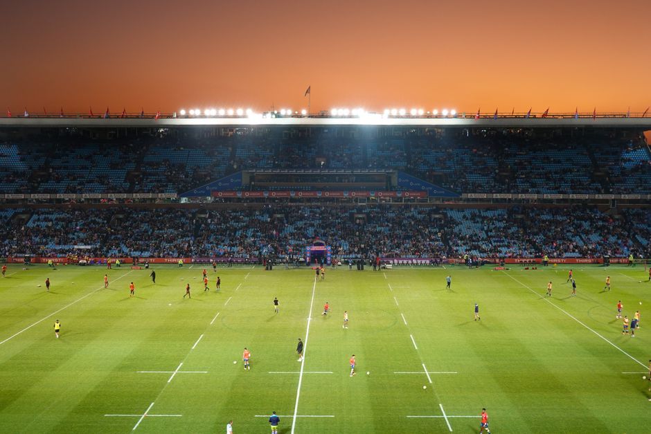 soccer stadium floodlights night match crowd no team crest