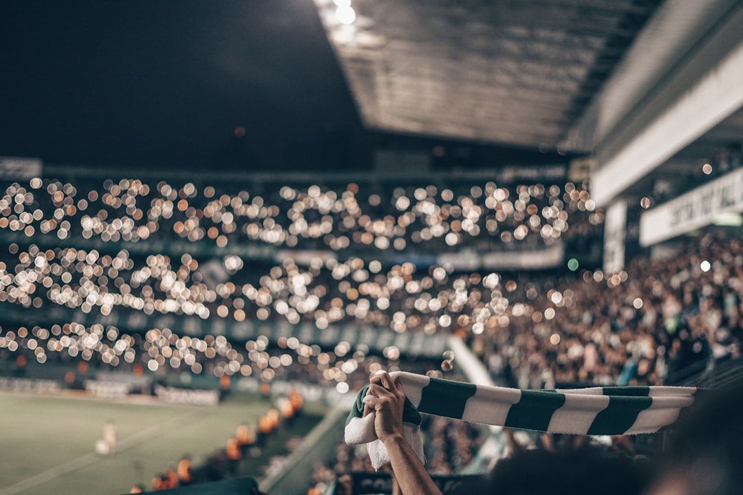 soccer stadium floodlights night match crowd no team crest