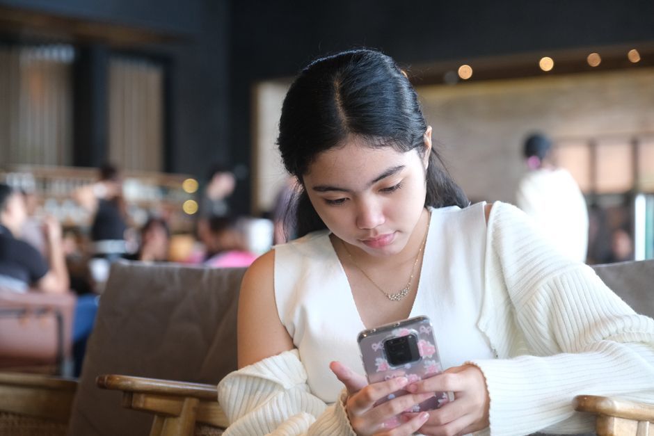 Thai youth using smartphone chatting online Bangkok