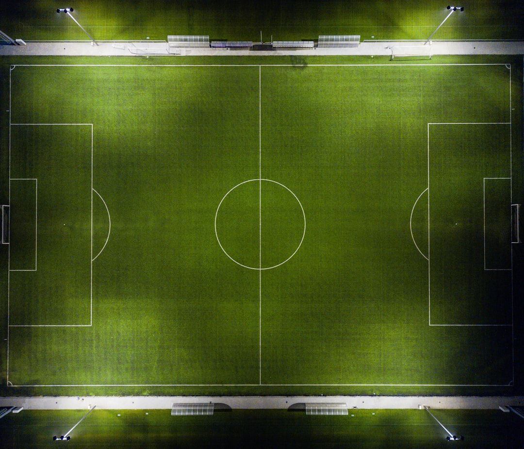 soccer stadium floodlights night match crowd no team crest