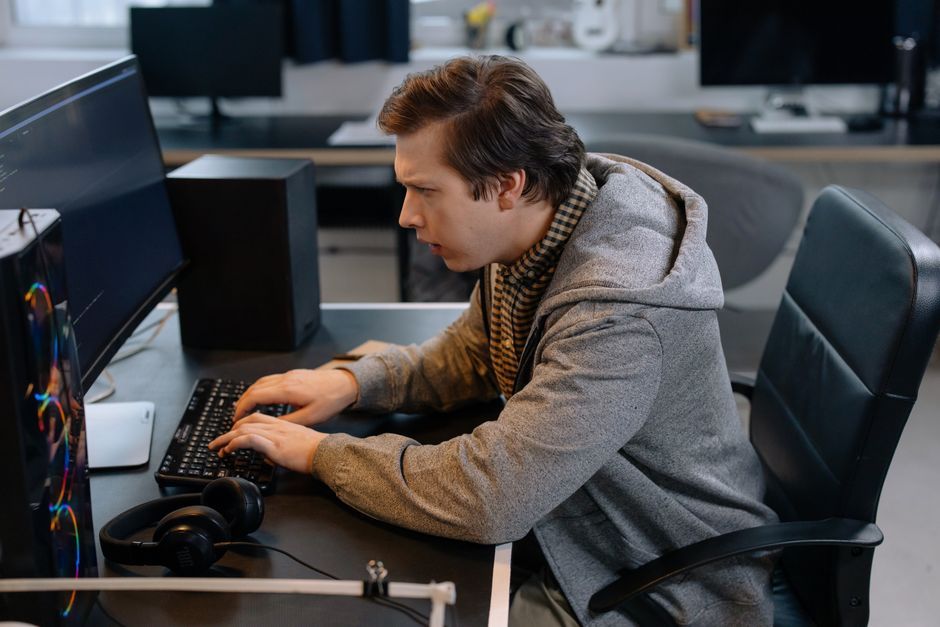 programmer working at desk computer screen