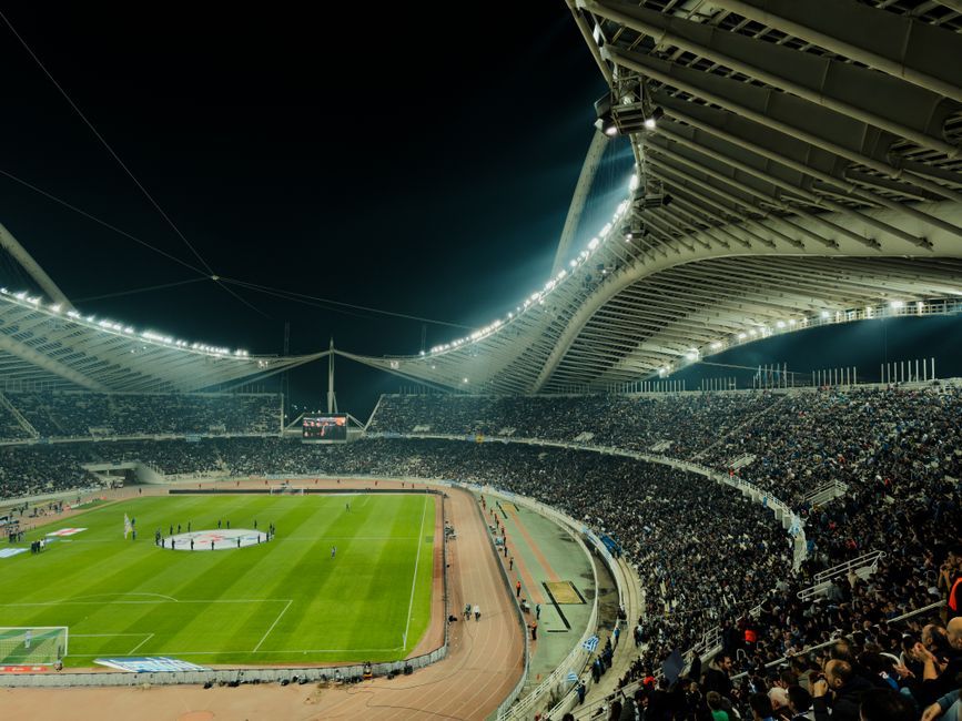 soccer stadium floodlights night match crowd no team crest