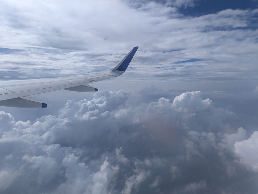 airplane wing view clouds sky