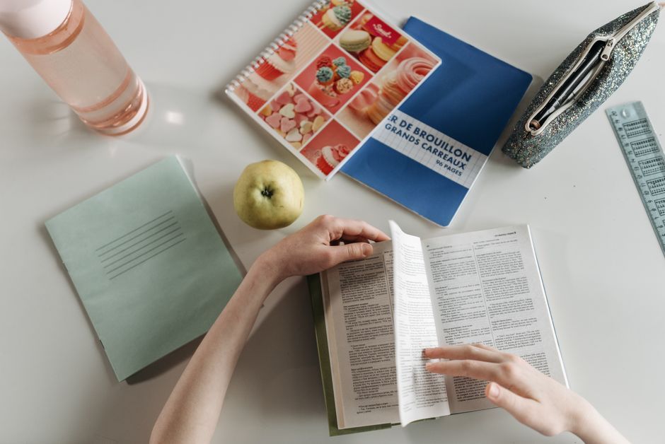 person studying foreign language notebook desk