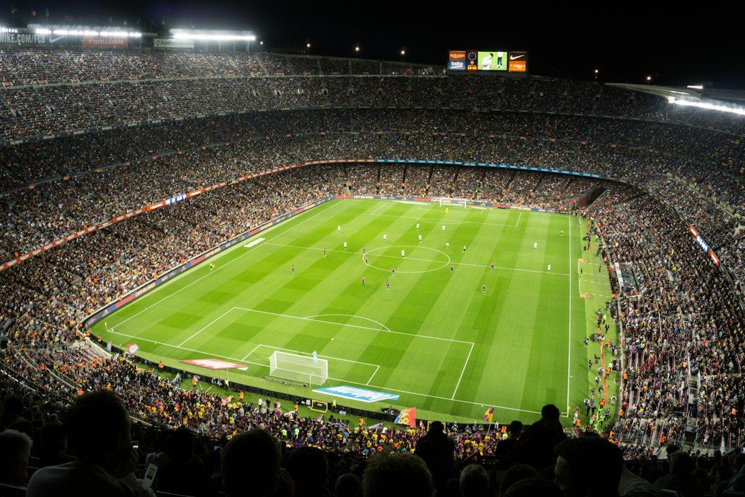 soccer stadium floodlights night match crowd no team crest