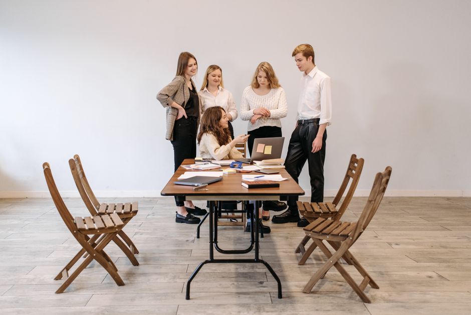 group of people gathering together indoor office workspace