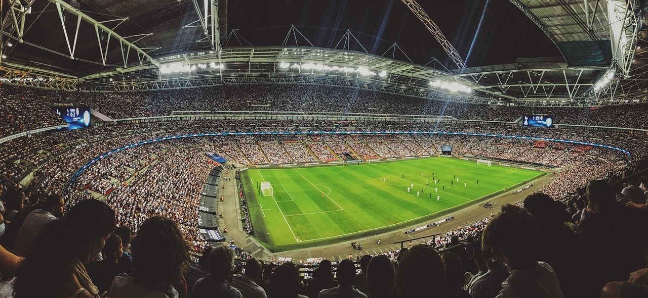 soccer stadium floodlights night match crowd no team crest