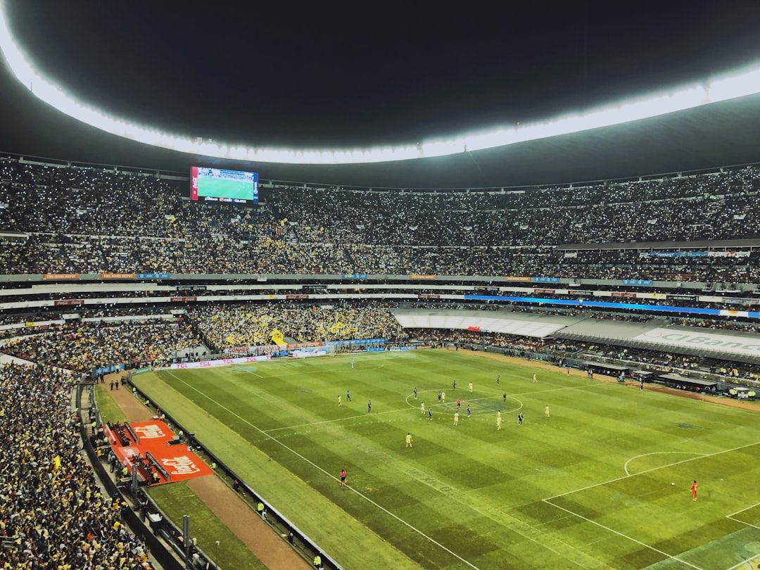 soccer stadium floodlights night match crowd no team crest