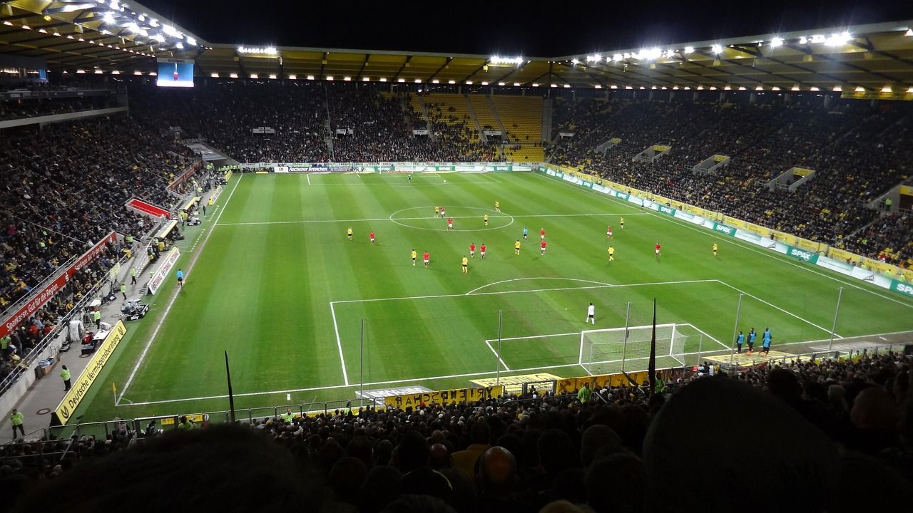 soccer stadium floodlights night match crowd no team crest