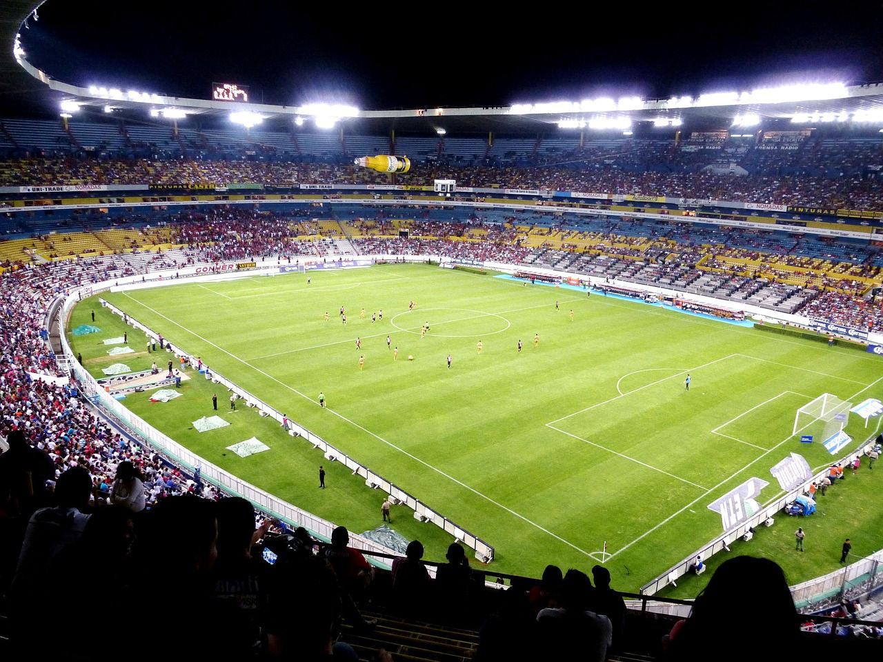 soccer stadium floodlights night match crowd no team crest