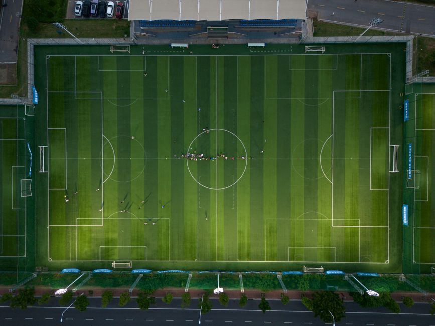 soccer stadium manager coach dugout pitch daytime