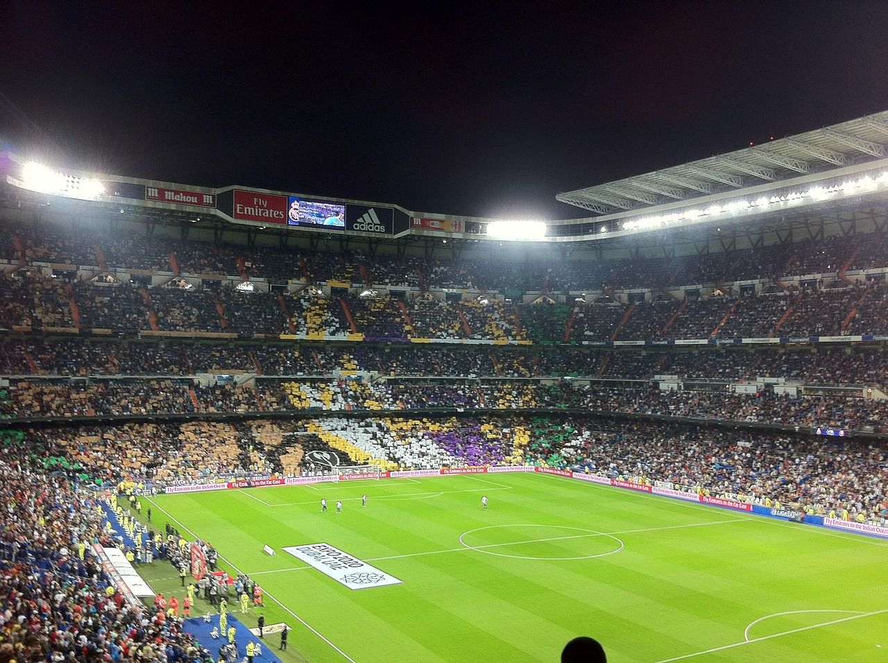 soccer stadium floodlights night match crowd no team crest