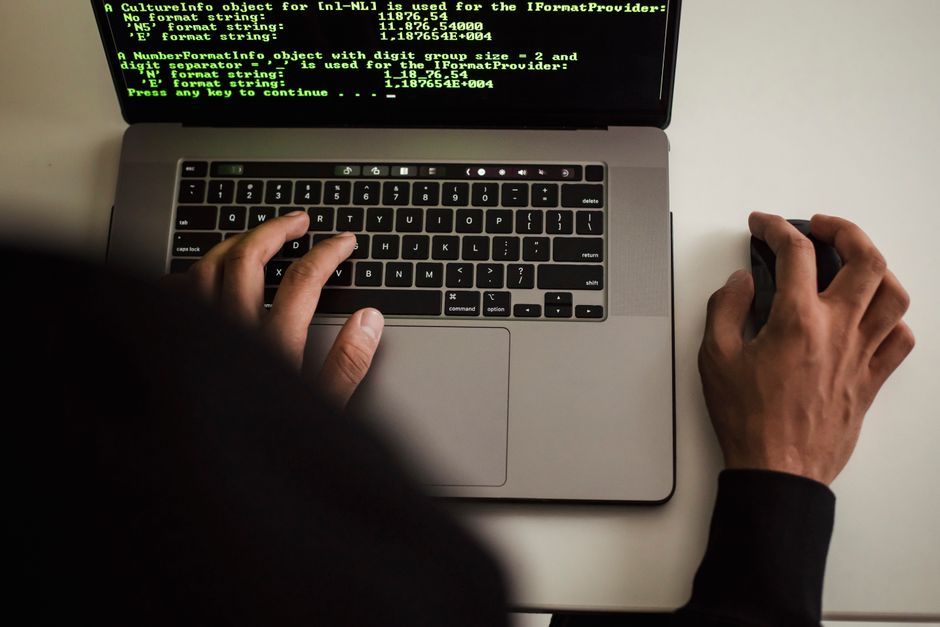 software engineer typing code screen dark mode