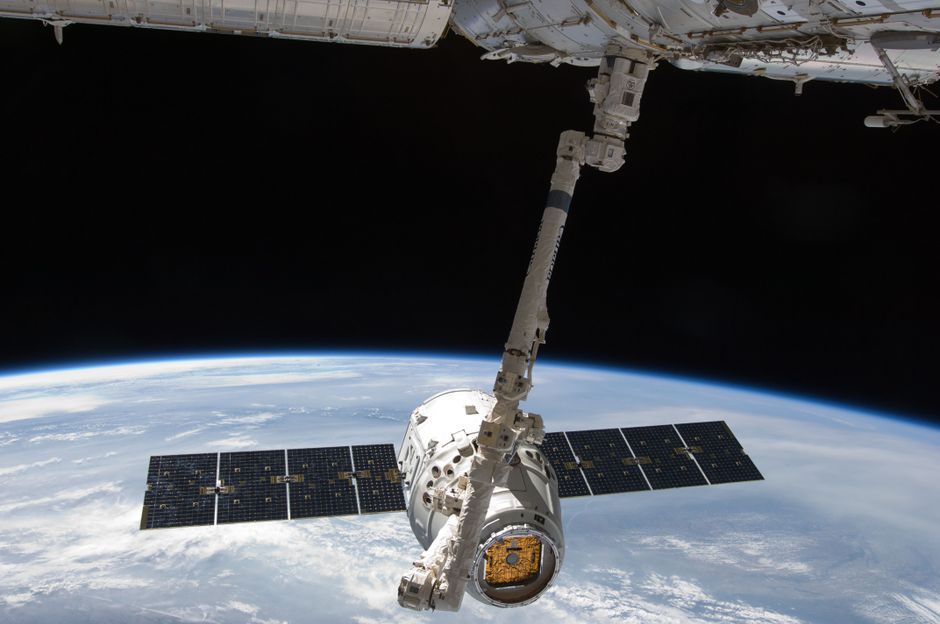 astronaut spacewalk solar panels Earth view