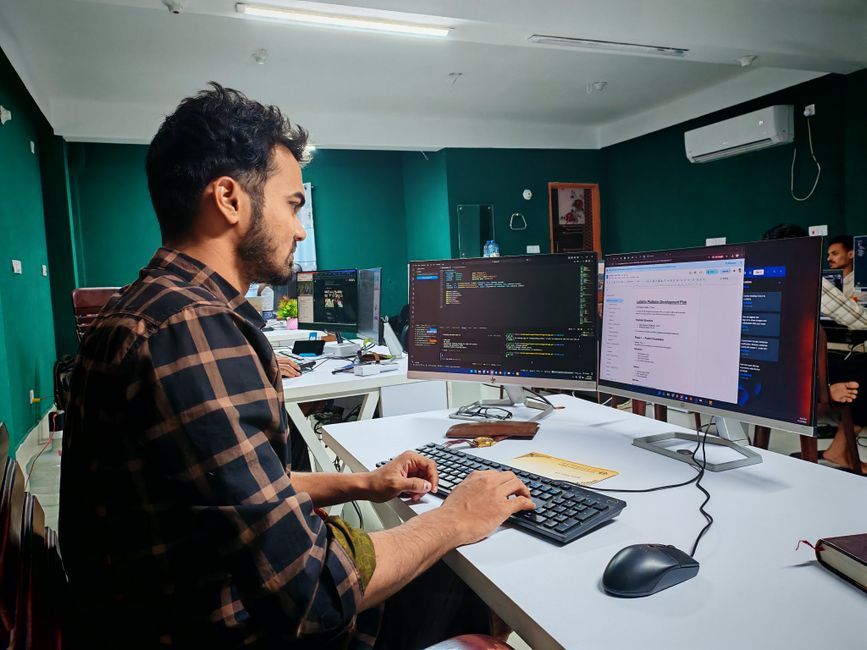 software developer writing code computer screen workspace