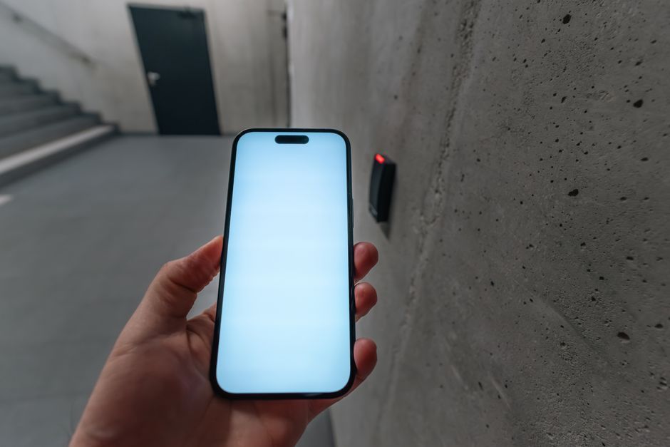 person scanning physical NFC key with phone