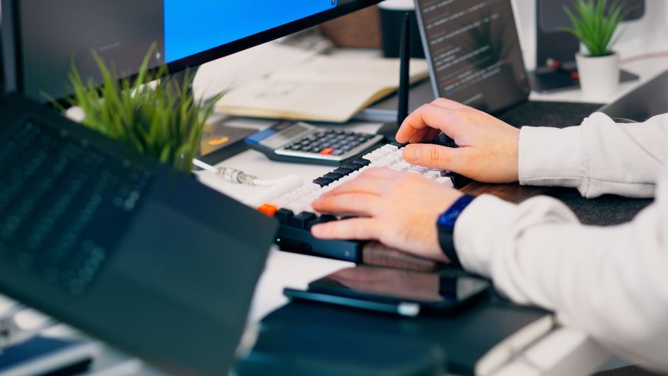 software developer typing typescript code office desk