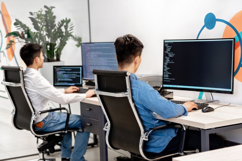 software developer writing code office desk