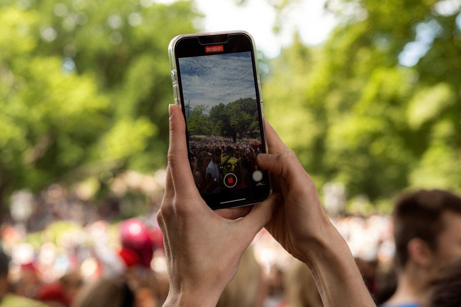 amusement park crowd smartphone recording