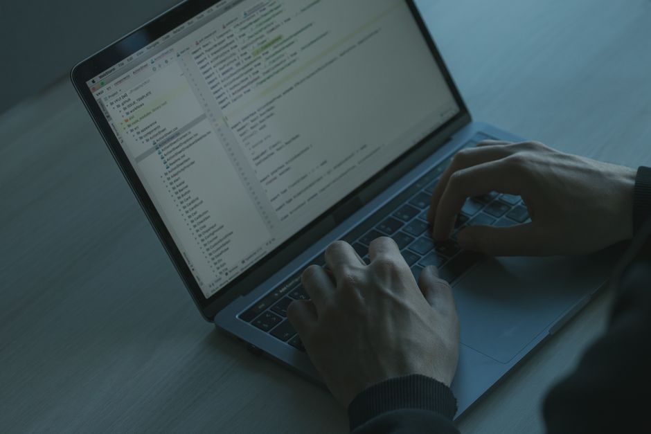 software developer writing code display screen
