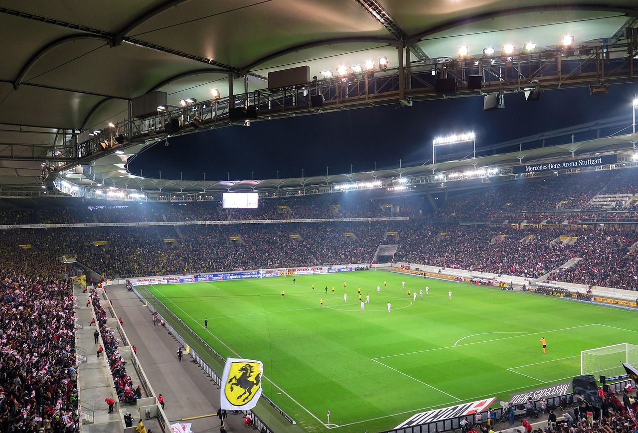 soccer stadium floodlights night match crowd no team crest