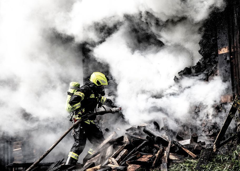 firefighter battling wildfire smoke