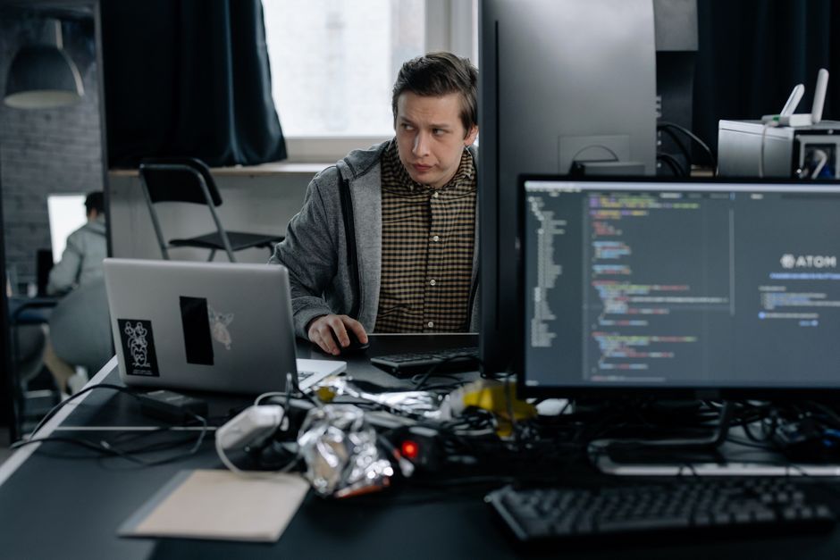 software developer writing code laptop office desk workspace