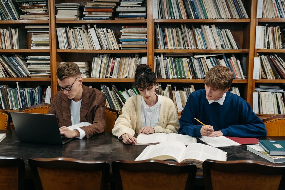 student notebook laptop studying library