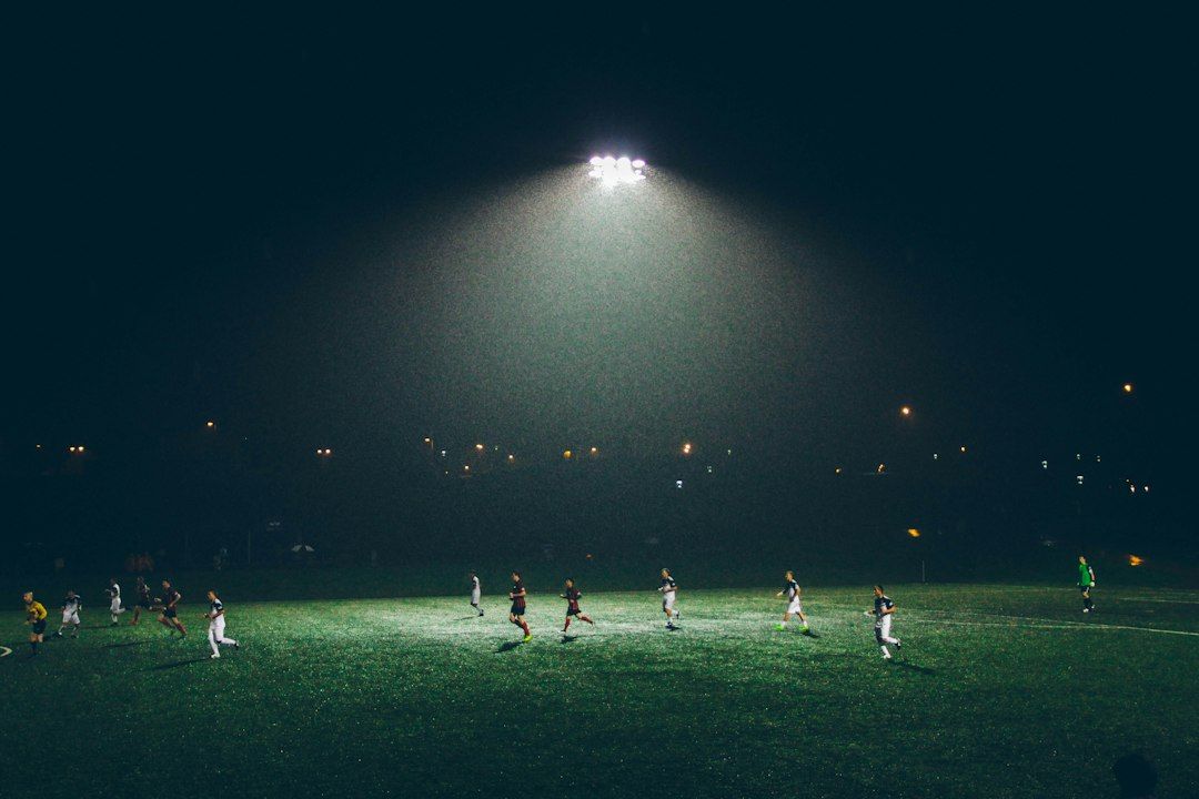 soccer stadium floodlights night match crowd no team crest