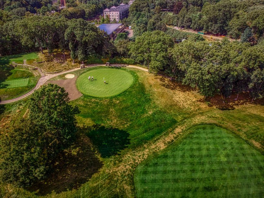 golf players walking on golf course green