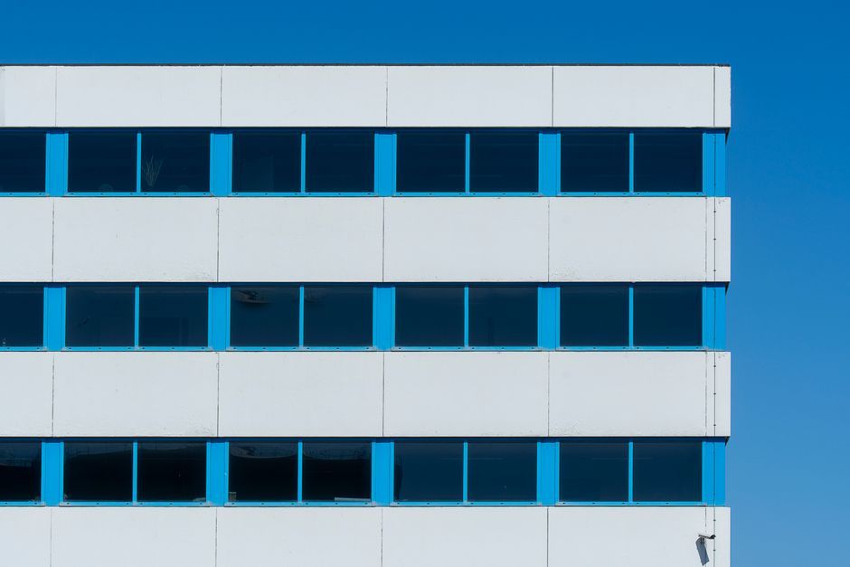 modern corporate office building exterior daytime no logo
