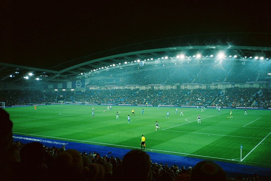 soccer stadium floodlights night match crowd no team crest