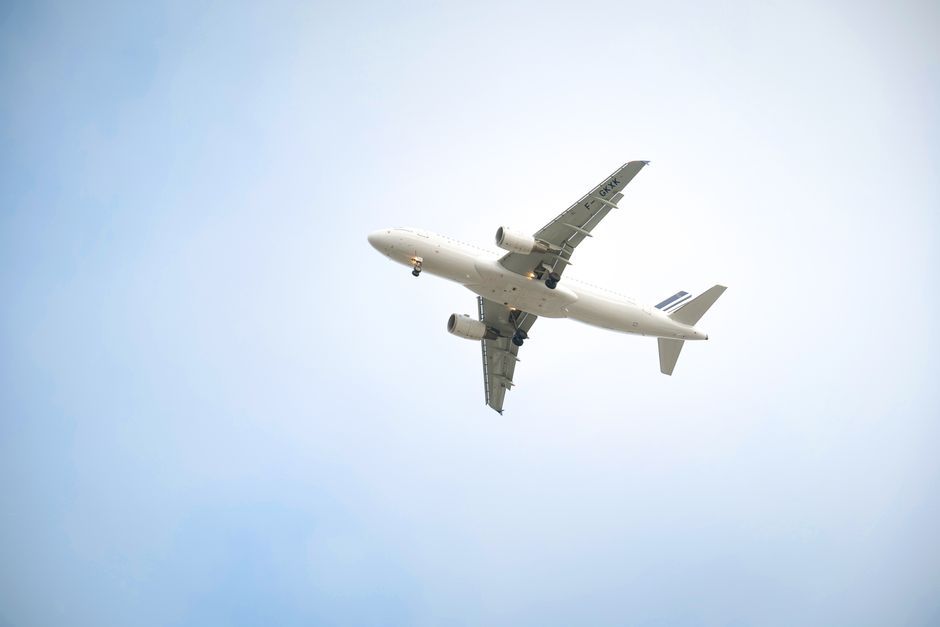 commercial passenger airplane wing flying sky